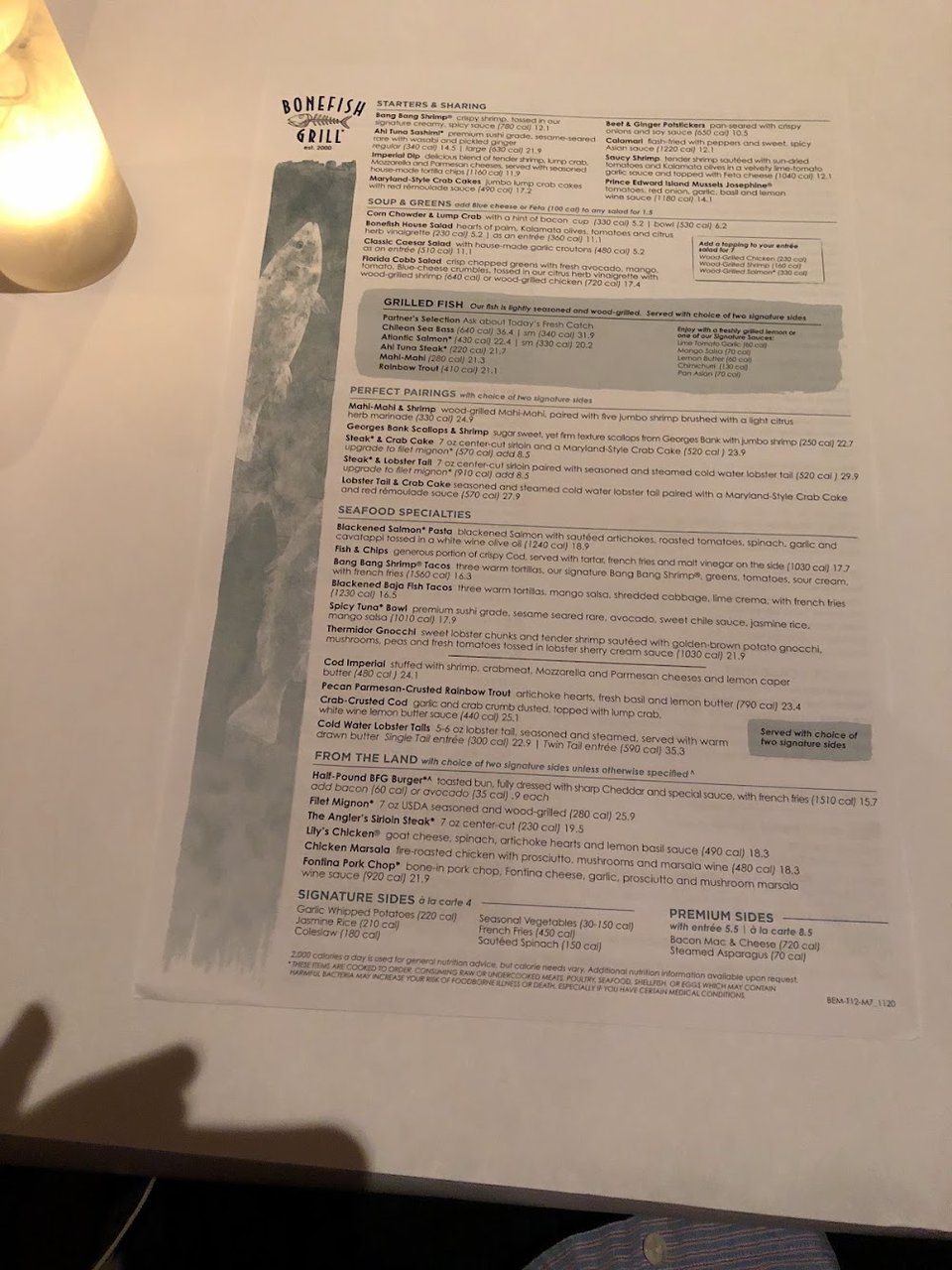 Printed menu with seafood, steak, and dessert sections.
