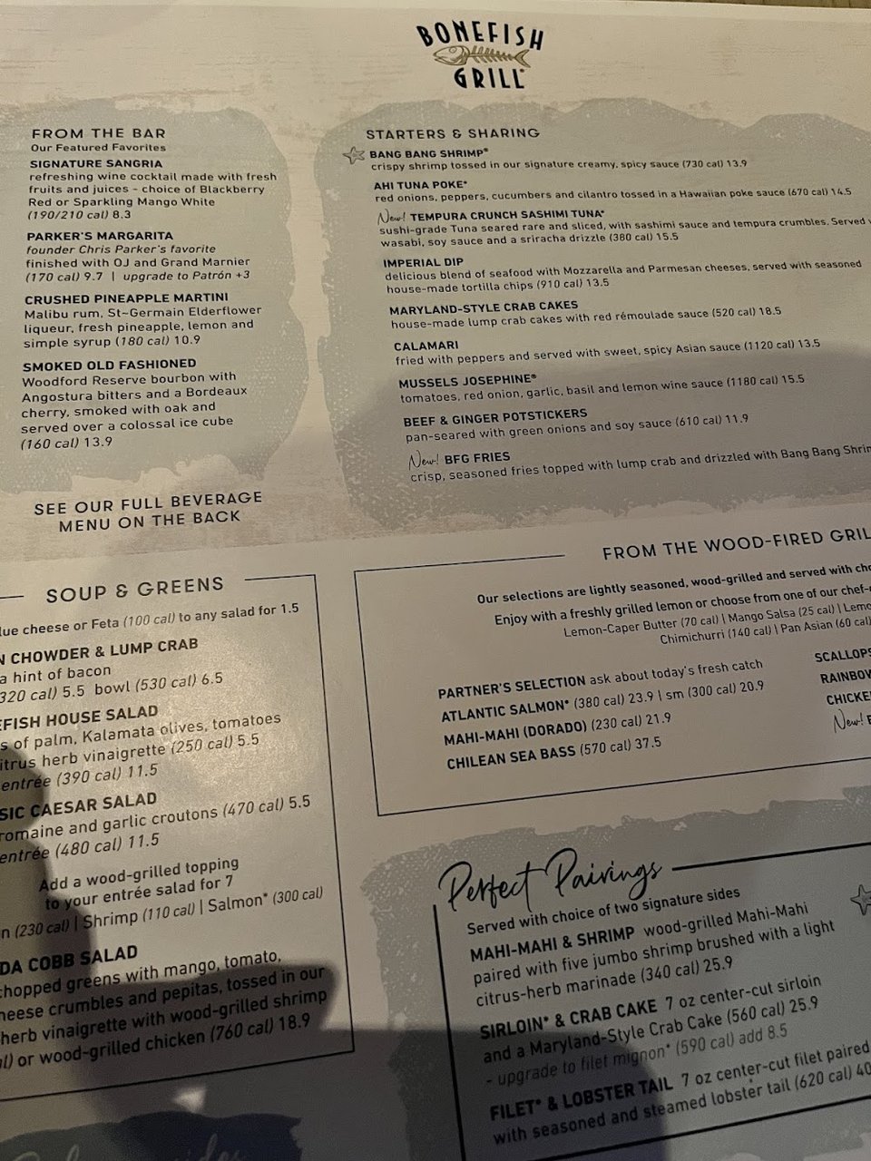 Restaurant menu showing starters, mains, and sides.